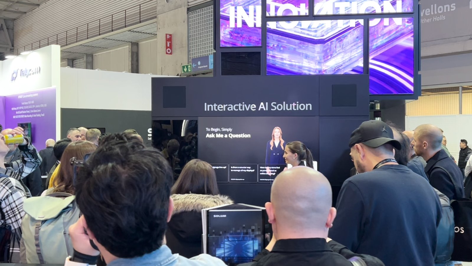 솔루엠 ISE 2025 전시부스 AI 도슨트 'Sarah'는 "Hi Sarah"라는 음성 호출로 등장해 사이니지의 특장점과 회사 철학을 영어로 소개하는 사례입니다.